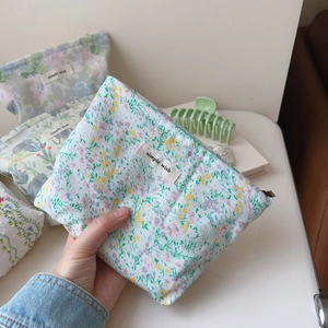 Close-up of floral and animal print cotton makeup bags with simple wish labels