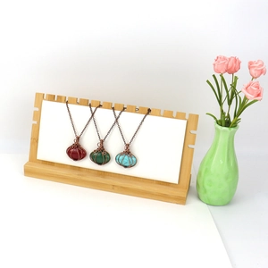 Detailed wire-wrapped pumpkin pendants in red agate, aventurine, and turquoise