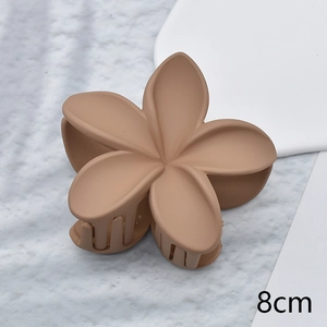 Close-up of 8cm brown plumeria hair claw clip with a premium matte textured finish