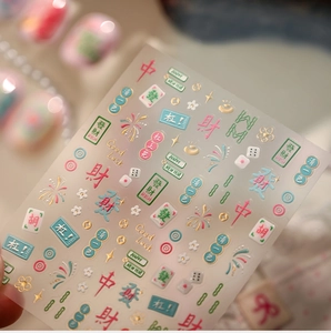 Detailed view of 3D embossed Mahjong nail stickers with gold New Year character motifs