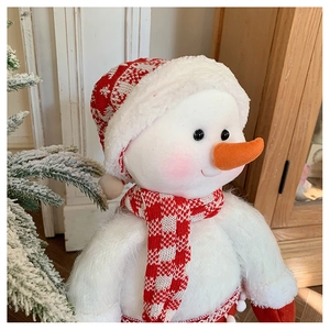Detail of knitted snowman doll with snowflake hat and scarf for Christmas decor