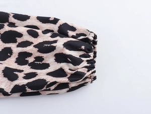 Detail of leopard print dress sleeve with elastic cuff and lantern sleeve style