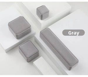 Set of four grey velvet jewelry boxes including ring, pendant, necklace and bracelet cases