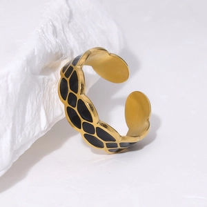 Detail of 18K gold plated titanium steel ring with black enamel rhombus patterns