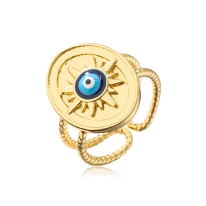 Detail of gold evil eye ring featuring a sunburst pattern and double rope chain band