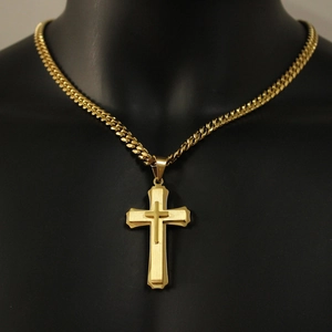 Gold layered cross pendant necklace on male mannequin with stainless steel cuban chain