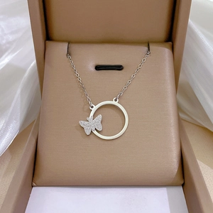 Close-up of a silver butterfly ring pendant in a premium gift box with silk lining