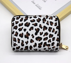 Close-up of leopard print card wallet with textured faux leather and gold zipper detail