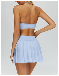 Detail view of light blue pleated tennis skirt back design with athletic fabric texture