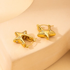 Detail view of gold-plated stainless steel star earrings with sparkling cubic zirconia
