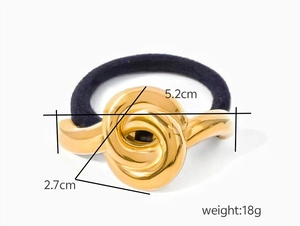 Close-up of black hair tie with 5.2cm golden metal twist knot decoration, weight 18g