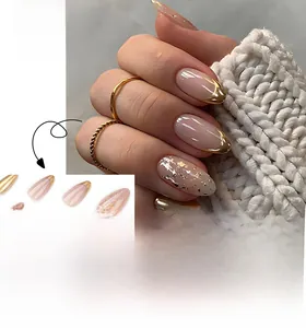 Detailed view of almond shaped nude pink press-on nails with elegant gold French tips