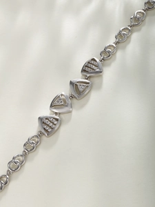 Detailed view of silver geometric triangle bracelet with sparkling zircon inlay