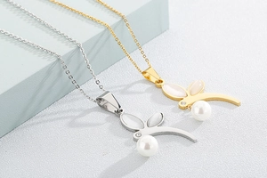 Detail of gold and silver rabbit pendants with oval opal ears and white pearl charms