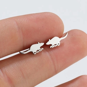 Cute silver mouse stud earrings held in hand to show the small minimalist size