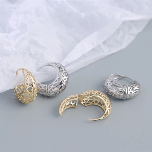 Detailed macro view of S925 sterling silver hoop earrings with hollow patterns