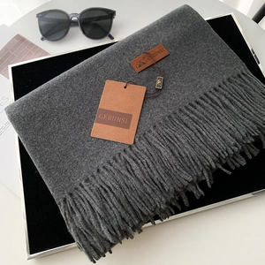Thick dark grey cashmere feel scarf with tassels and premium leather brand label