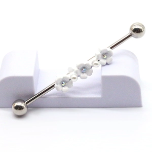 Industrial barbell earring with three white flowers and white pearls on silver metal bar