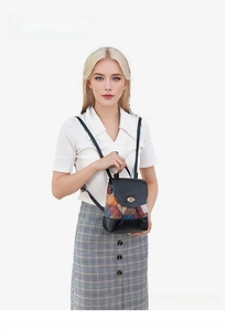 Detailed shot of mini drawstring backpack with multi-color leather patchwork and twist lock