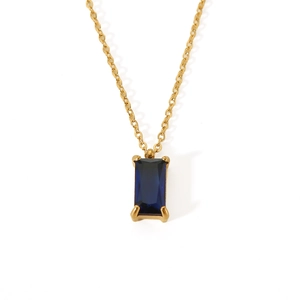 Macro detail of rectangle blue zircon pendant on 18K gold-plated stainless steel chain