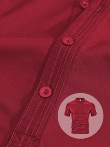 Detail of red short sleeve polo shirt featuring henley collar and pleated placket texture
