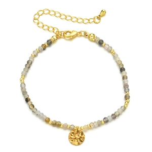 Detail of multi-color faceted stone beads with gold hammered disc charm and lobster clasp