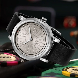 Detail of unique game-themed watch dial with black leather strap on a green felt table