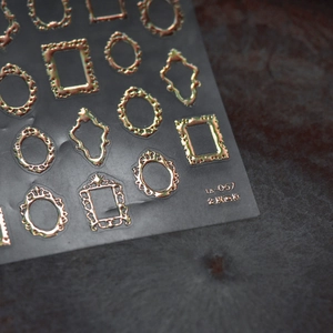 Macro view of Lu-057 vintage gold embossed frame nail art stickers with metallic finish