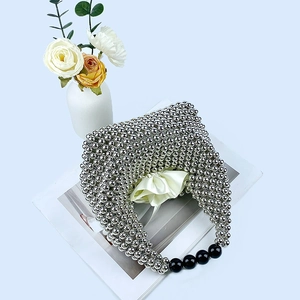 Top view of a silver beaded pillow bag with black accent beads and a stylish interior lining