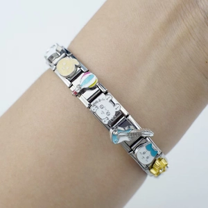 Detailed shot of an Italian charm bracelet featuring cartoon pendants on stainless steel links
