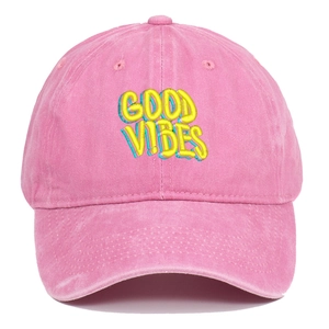 Close-up of GOOD VIBES colorful embroidery on a pink washed cotton baseball cap