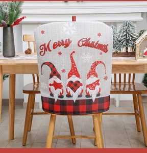 Close-up of grey burlap chair cover with red plaid gnome design for Christmas decor