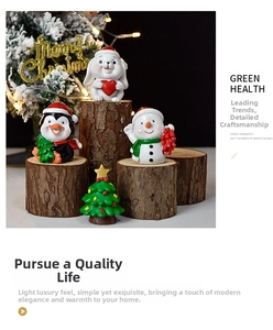 Detailed view of Christmas resin miniatures including rabbit and penguin on wood