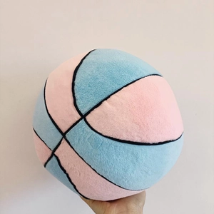 Detail of pink and blue plush basketball pillow showing soft texture and stitching