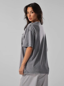 Detail view of washed grey cotton oversized t-shirt with pixel art graphic on back