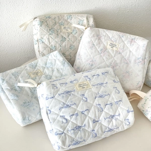 Quilted cotton makeup bags with floral and cat prints in a set of four soft colors