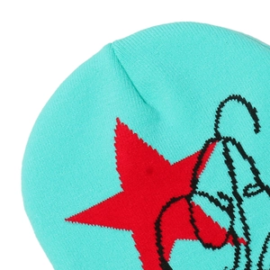 Detail shot of mint green knit beanie featuring red star jacquard and graffiti texture