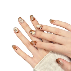 Handmade orange gradient leopard print press-on nails with stars and rhinestones