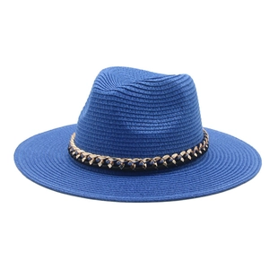 Detailed view of dark blue woven straw panama hat with a stylish golden metal chain band