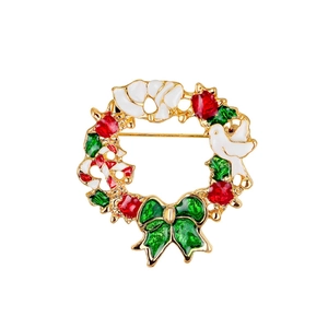 Detailed view of Christmas wreath brooch with colorful enamel holly leaves and berries