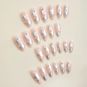 Almond shaped press-on nails with silver stars and rhinestones on a nude pink base