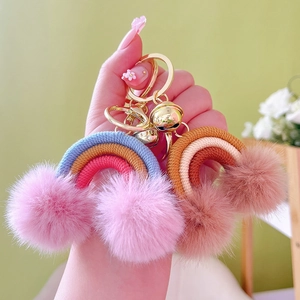 Handheld bohemian rainbow keychain with colorful woven rope and soft plush pom poms