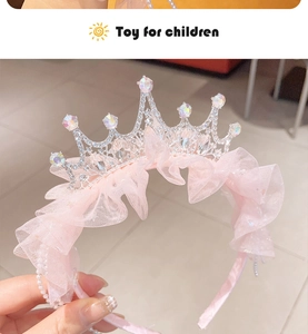 Detailed view of kids rhinestone crown headband with pink mesh and sparkling crystals