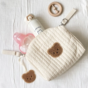 Quilted cotton diaper bag with bear embroidery and stroller straps for storage