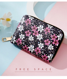 Close-up of black women's small card wallet with pink and white daisy floral patterns
