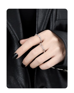 Detail view of S925 silver beaded and twisted woven rings on a model hand with black leather