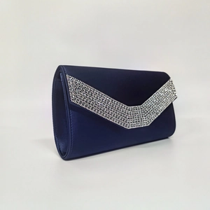 Detail of navy blue satin clutch bag with V-shaped rhinestone embellishment and elegant texture