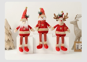 Detail of Christmas plush trio with Santa, snowman and reindeer on white display cubes