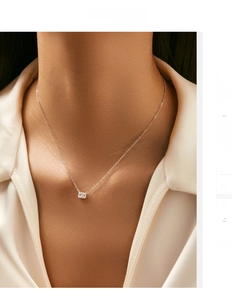 Detailed shot of an emerald-cut crystal necklace in S925 sterling silver worn by model