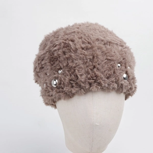 Close-up of beige faux fur beret featuring elegant silver bead detailing and plush texture